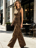 Woman's leopard print two-piece ensemble features a round-neck, sleeveless, irregularly cropped vest paired with flared, wide-leg trousers, presenting an elegant combination suitable for both streetwear and club attire